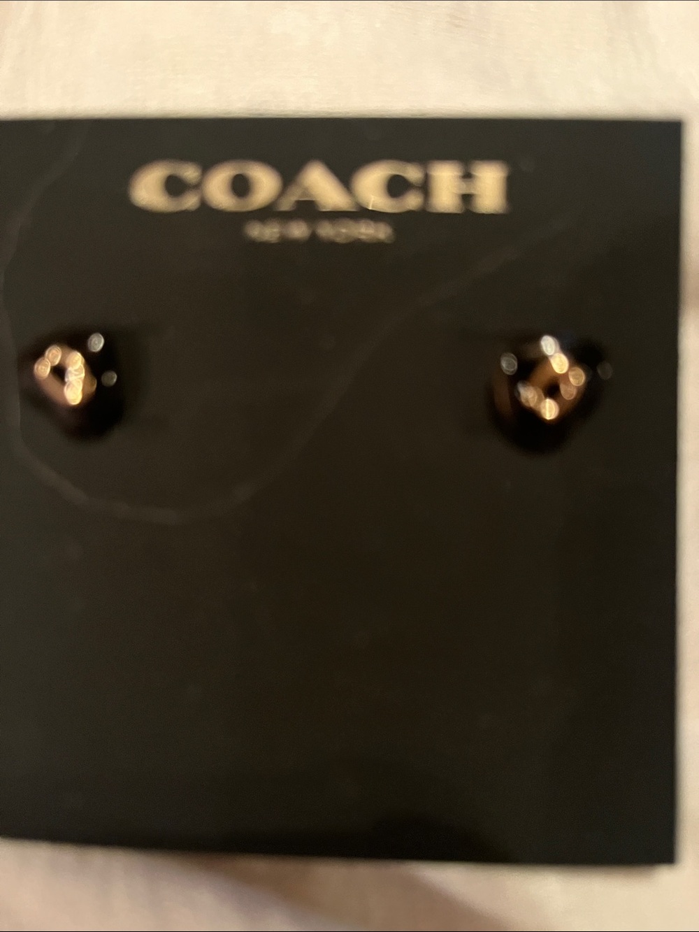 COACH Black and Gold Heart Logo Stud Earrings